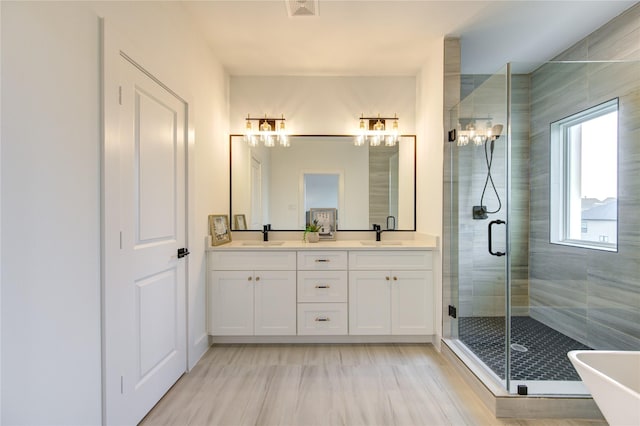 2312 Reinerman St, Houston, TX 77007 - bathroom with double vanity, a shower stall, and a freestanding tub