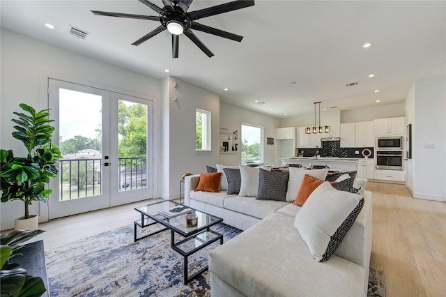 2312 Reinerman St, Houston, TX 77007 - living room with recessed lighting, light wood-style flooring, a ceiling fan, french doors, and baseboards