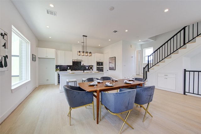 2312 Reinerman St, Houston, TX 77007 - dining area featuring light wood-style floors, stairway, recessed lighting, and baseboards