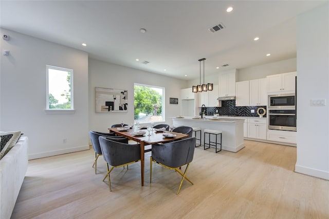 2312 Reinerman St, Houston, TX 77007 - dining area featuring light wood-type flooring, recessed lighting, and baseboards