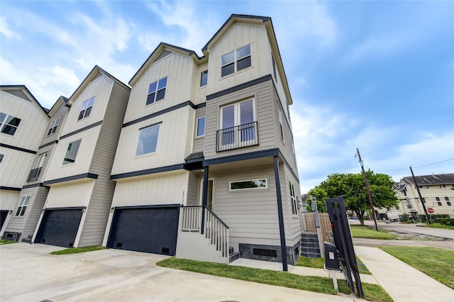 2312 Reinerman St, Houston, TX 77007 - townhome / multi-family property featuring a garage, board and batten siding, and driveway