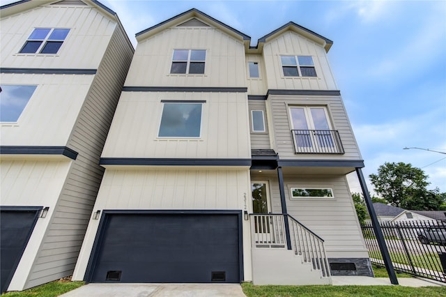 2312 Reinerman St, Houston, TX 77007 - view of property with a garage, concrete driveway, and board and batten siding