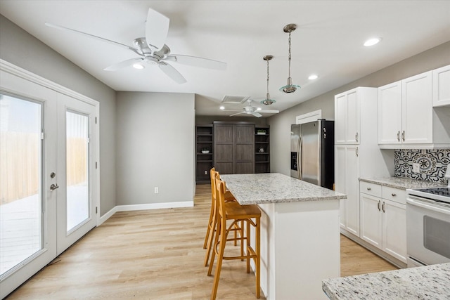 2050 Marnel Rd, Houston, TX 77055 - kitchen featuring stainless steel fridge, white stove, a ceiling fan, plenty of natural light, and recessed lighting