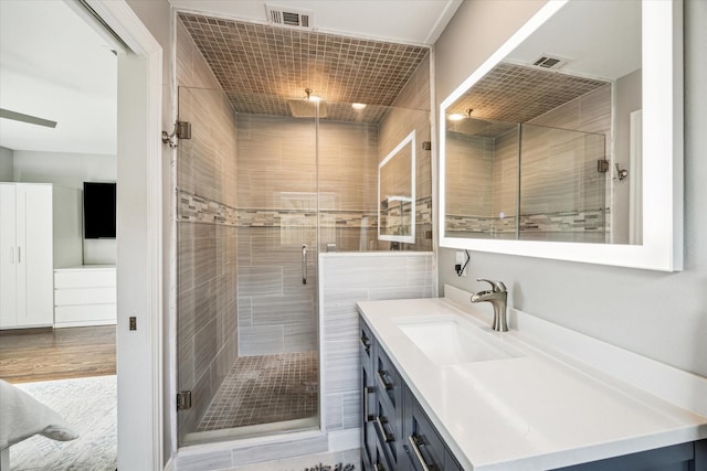 2050 Marnel Rd, Houston, TX 77055 - full bathroom featuring vanity, a shower stall, and wood finished floors