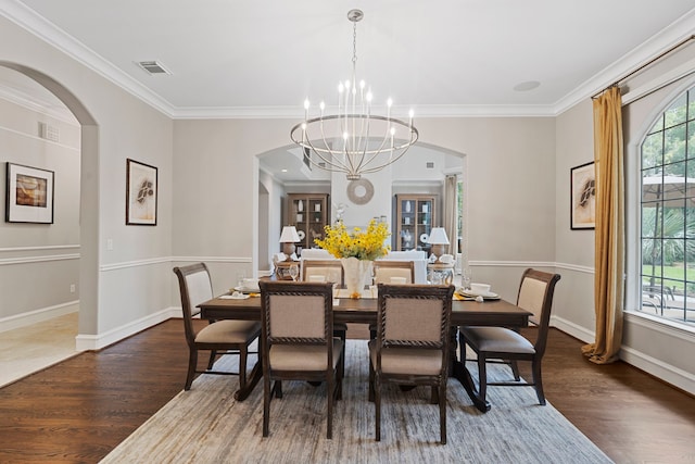26 Commanders Pt, Missouri City, TX 77459 - dining area featuring arched walkways, wood finished floors, ornamental molding, and plenty of natural light