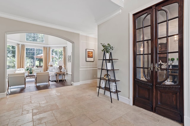 26 Commanders Pt, Missouri City, TX 77459 - entrance foyer with arched walkways, baseboards, stone tile floors, and crown molding