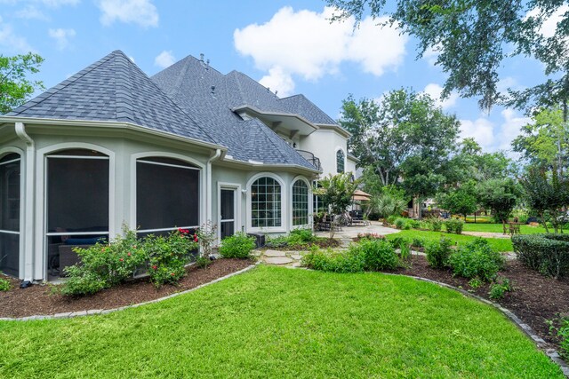 26 Commanders Pt, Missouri City, TX 77459 - rear view of house with a shingled roof, a lawn, stucco siding, and a patio area
