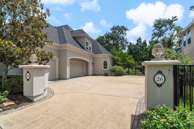 26 Commanders Pt, Missouri City, TX 77459 - view of property exterior with concrete driveway, a shingled roof, stucco siding, and a garage