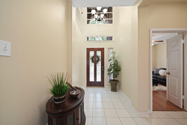 1123 Mariner Cv, Sugar Land, TX 77498 - foyer entrance featuring light tile patterned floors, a chandelier, baseboards, and a towering ceiling