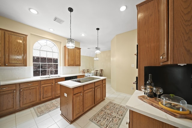 1123 Mariner Cv, Sugar Land, TX 77498 - kitchen with a sink, brown cabinets, a kitchen island, tasteful backsplash, and recessed lighting