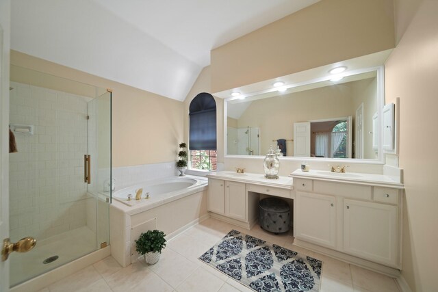 1123 Mariner Cv, Sugar Land, TX 77498 - bathroom with double vanity, a shower stall, a bath, vaulted ceiling, and tile patterned floors