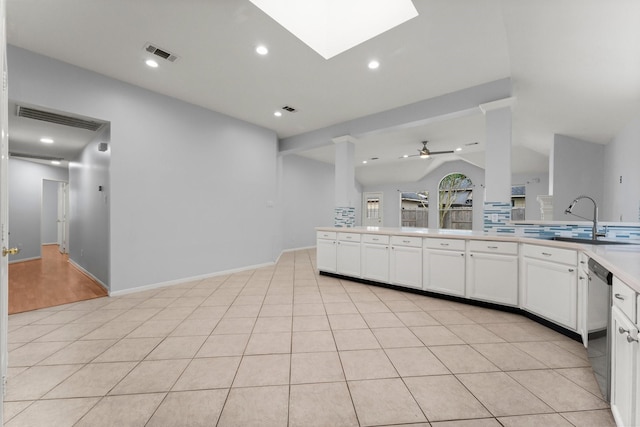 1030 Evandale Ln, Sugar Land, TX 77479 - kitchen featuring stainless steel dishwasher, a sink, white cabinetry, a ceiling fan, and lofted ceiling