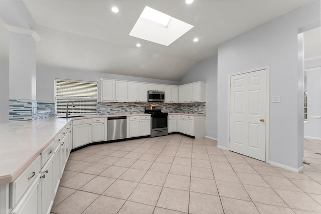 1030 Evandale Ln, Sugar Land, TX 77479 - kitchen with stainless steel appliances, a skylight, a sink, decorative backsplash, and lofted ceiling