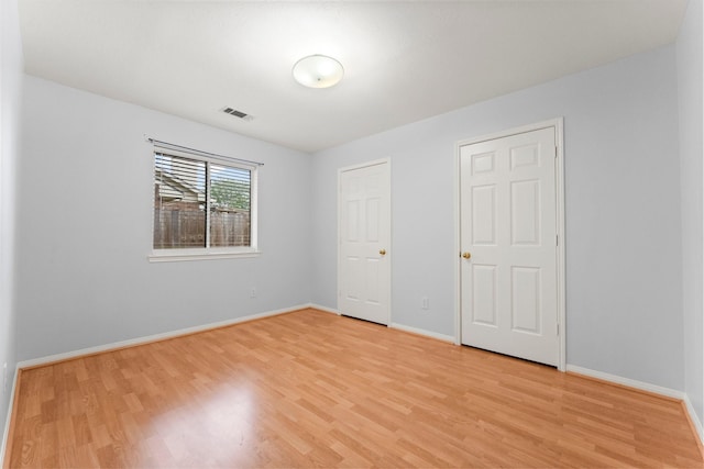 1030 Evandale Ln, Sugar Land, TX 77479 - unfurnished bedroom with light wood finished floors and baseboards