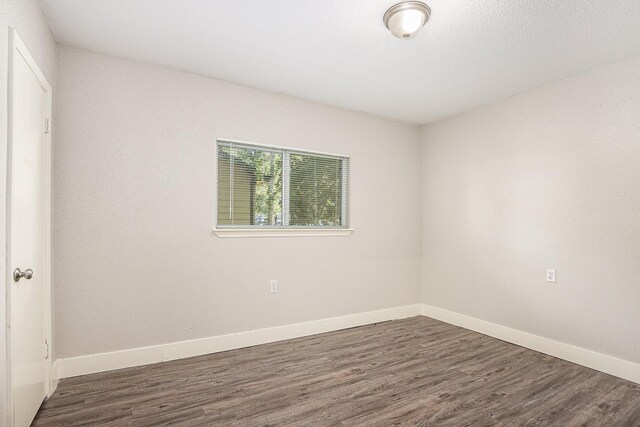 2203 Crosscoach Ln, Katy, TX 77449 - empty room featuring wood finished floors and baseboards