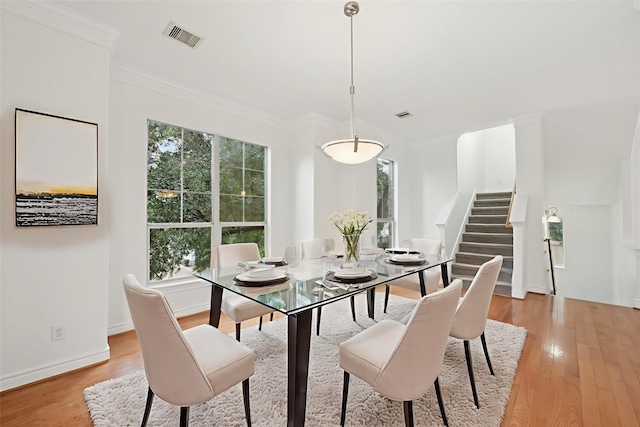 5731 Kansas St, Houston, TX 77007 - dining room with stairs, light wood finished floors, ornamental molding, and baseboards