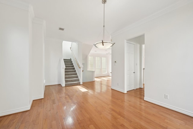 5731 Kansas St, Houston, TX 77007 - spare room with stairway, light wood finished floors, ornamental molding, and baseboards
