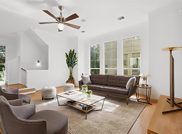 5731 Kansas St, Houston, TX 77007 - living area featuring wood finished floors, ceiling fan, crown molding, and stairs