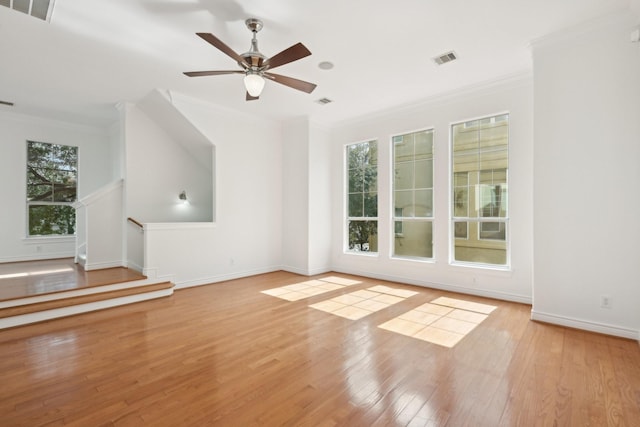 5731 Kansas St, Houston, TX 77007 - unfurnished living room featuring crown molding, wood finished floors, a ceiling fan, and baseboards
