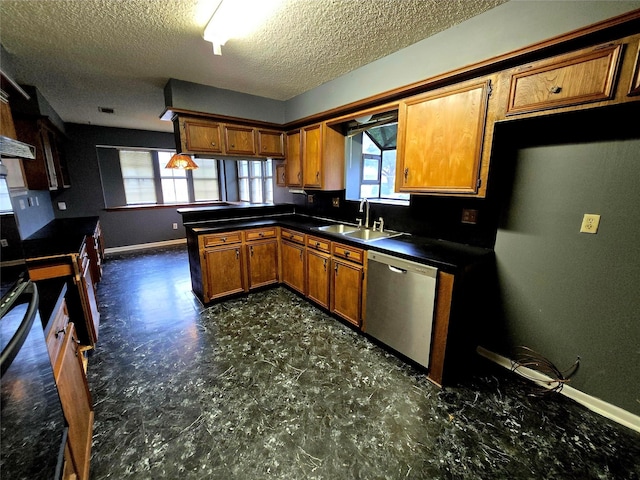 5000 Magnolia Ln, Bay City, TX 77414 - kitchen with dishwasher, a sink, brown cabinets, baseboards, and a textured ceiling