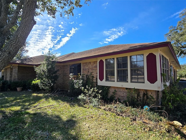5000 Magnolia Ln, Bay City, TX 77414 - view of property exterior with brick siding and a lawn