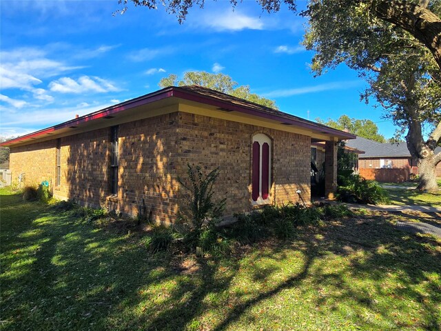 5000 Magnolia Ln, Bay City, TX 77414 - view of side of property featuring brick siding and a lawn