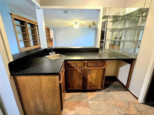 5000 Magnolia Ln, Bay City, TX 77414 - bar area featuring a sink, a ceiling fan, light stone finish floors, and baseboards