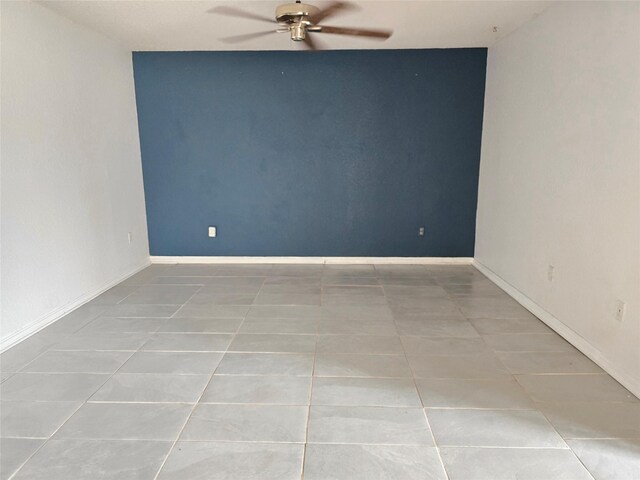 5000 Magnolia Ln, Bay City, TX 77414 - unfurnished room with tile patterned flooring, a ceiling fan, and baseboards