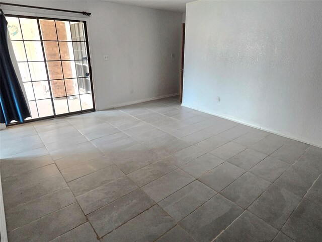 5000 Magnolia Ln, Bay City, TX 77414 - empty room featuring tile patterned flooring and baseboards