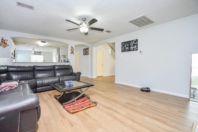 20418 Linden Tree Dr, Katy, TX 77449 - living room featuring arched walkways, a ceiling fan, and light wood-type flooring