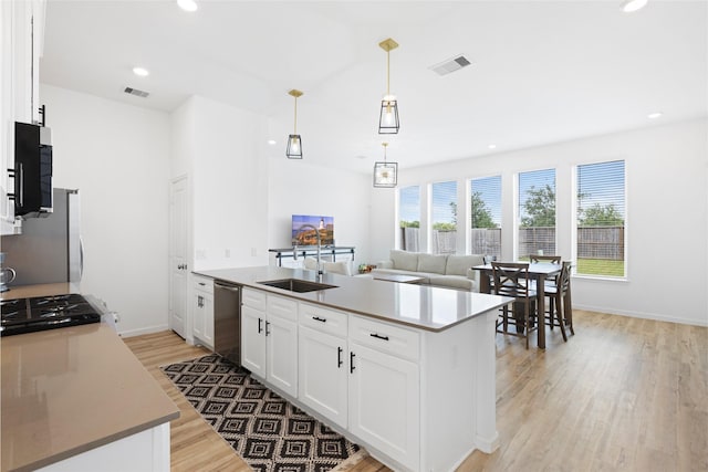 4234 Balboa Dr, Iowa Colony, TX 77583 - kitchen featuring a sink, light wood-style floors, stainless steel appliances, white cabinets, and baseboards