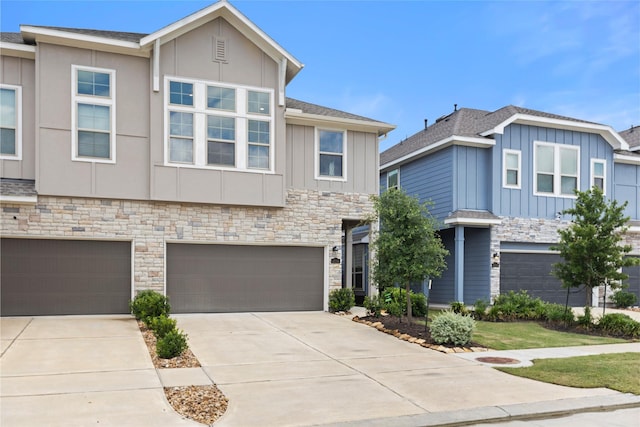 4234 Balboa Dr, Iowa Colony, TX 77583 - view of front of house with board and batten siding, stone siding, a garage, driveway, and a shingled roof