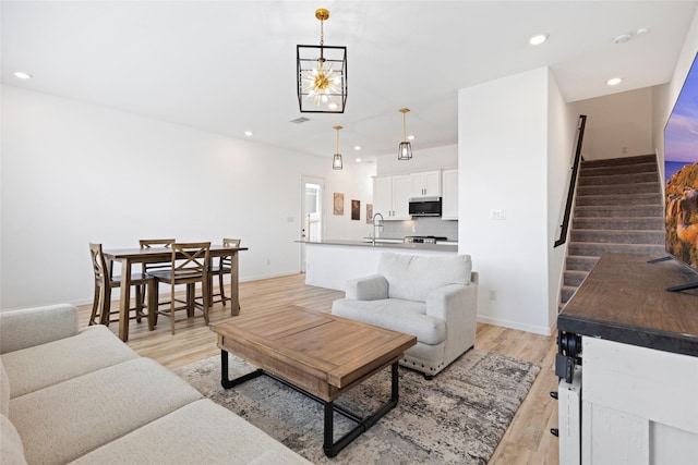 4234 Balboa Dr, Iowa Colony, TX 77583 - living room with stairs, light wood finished floors, recessed lighting, and baseboards