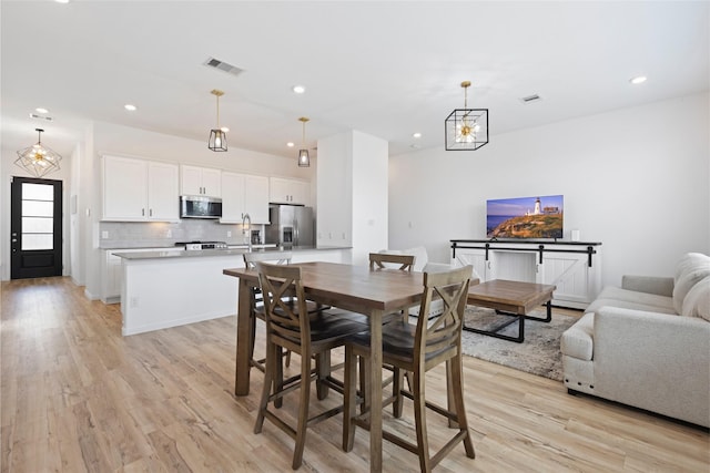 4234 Balboa Dr, Iowa Colony, TX 77583 - dining room featuring light wood finished floors, recessed lighting, and a chandelier