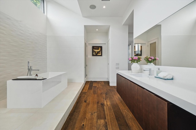 2110 Tangley St, Houston, TX 77005 - bathroom featuring vanity, hardwood / wood-style flooring, a bath, and recessed lighting