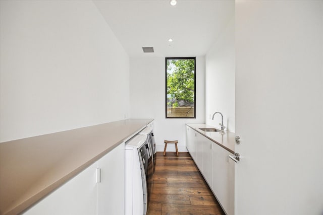 2110 Tangley St, Houston, TX 77005 - kitchen with white cabinets, recessed lighting, dark wood-style floors, light countertops, and washer / clothes dryer