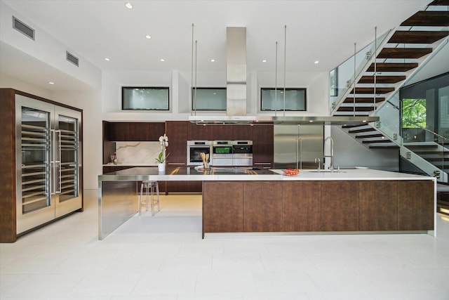 2110 Tangley St, Houston, TX 77005 - kitchen with stainless steel built in fridge, modern cabinets, wine cooler, light countertops, and recessed lighting