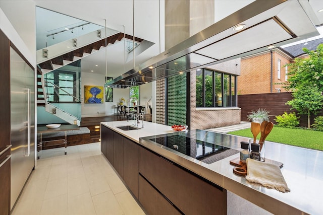2110 Tangley St, Houston, TX 77005 - kitchen with dark brown cabinetry, modern cabinets, and black electric stovetop