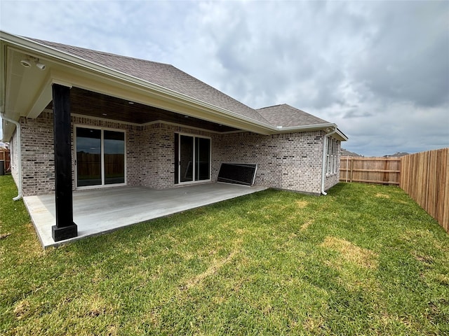 2804 Spector Dr, Bryan, TX 77808 - back of house featuring a patio, brick siding, and a shingled roof