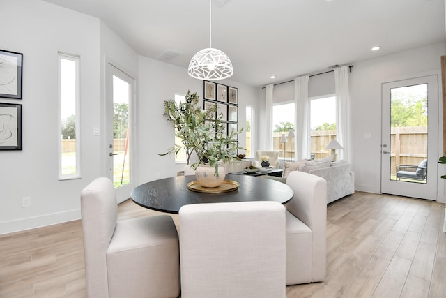 4011 Boho Ln, Houston, TX 77045 - dining room featuring light wood-style flooring, recessed lighting, and baseboards