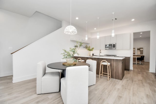 4011 Boho Ln, Houston, TX 77045 - dining room featuring recessed lighting, light wood-style floors, and baseboards