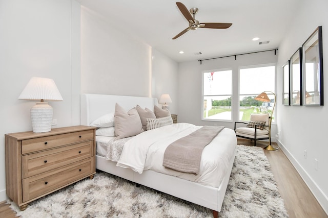 4011 Boho Ln, Houston, TX 77045 - bedroom with light wood-type flooring, baseboards, recessed lighting, and a ceiling fan