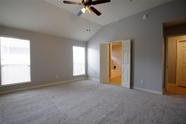 19915 Mason Creek Dr, Katy, TX 77449 - unfurnished bedroom with vaulted ceiling, multiple windows, carpet flooring, and baseboards