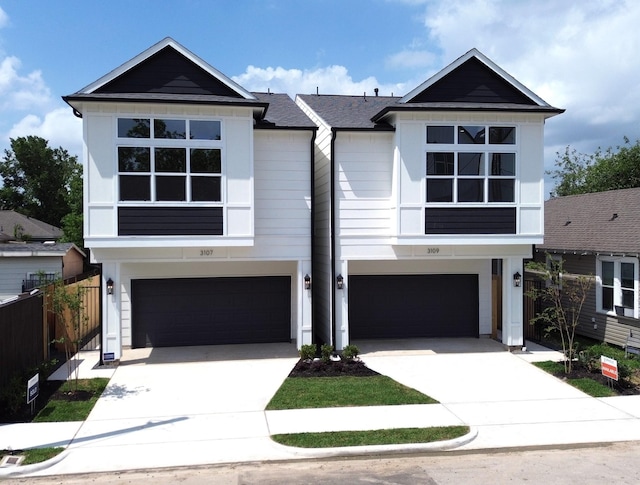 3109 Orange St, Houston, TX 77020 - view of front of house featuring an attached garage, driveway, and roof with shingles