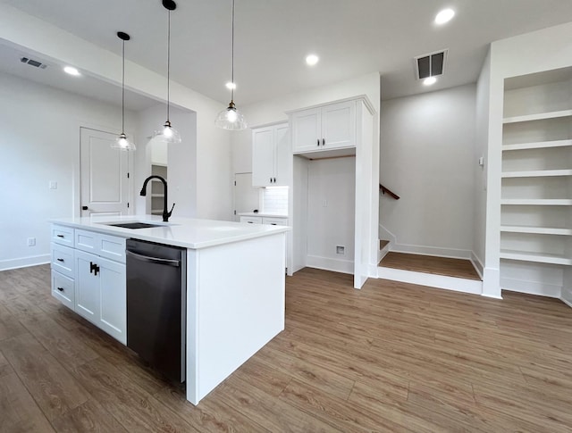 3109 Orange St, Houston, TX 77020 - kitchen with stainless steel dishwasher, white cabinetry, wood finished floors, light countertops, and recessed lighting