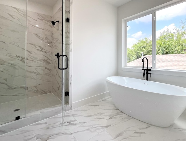 3109 Orange St, Houston, TX 77020 - bathroom featuring a marble finish shower, a freestanding bath, and marble look tile flooring