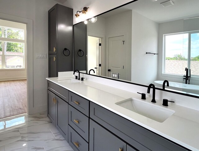 3109 Orange St, Houston, TX 77020 - full bath featuring plenty of natural light, double vanity, marble finish floors, and baseboards