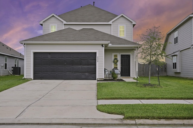 5330 Briana Dee Dr, Rosharon, TX 77583 - traditional-style house featuring driveway, an attached garage, a lawn, a shingled roof, and central air condition unit