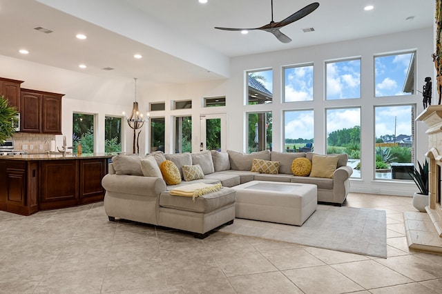4003 N Creekmont Dr, Fresno, TX 77545 - living area featuring a ceiling fan, recessed lighting, a chandelier, a fireplace with raised hearth, and light tile patterned floors