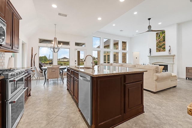 4003 N Creekmont Dr, Fresno, TX 77545 - kitchen featuring a sink, stainless steel appliances, healthy amount of natural light, a fireplace, and recessed lighting